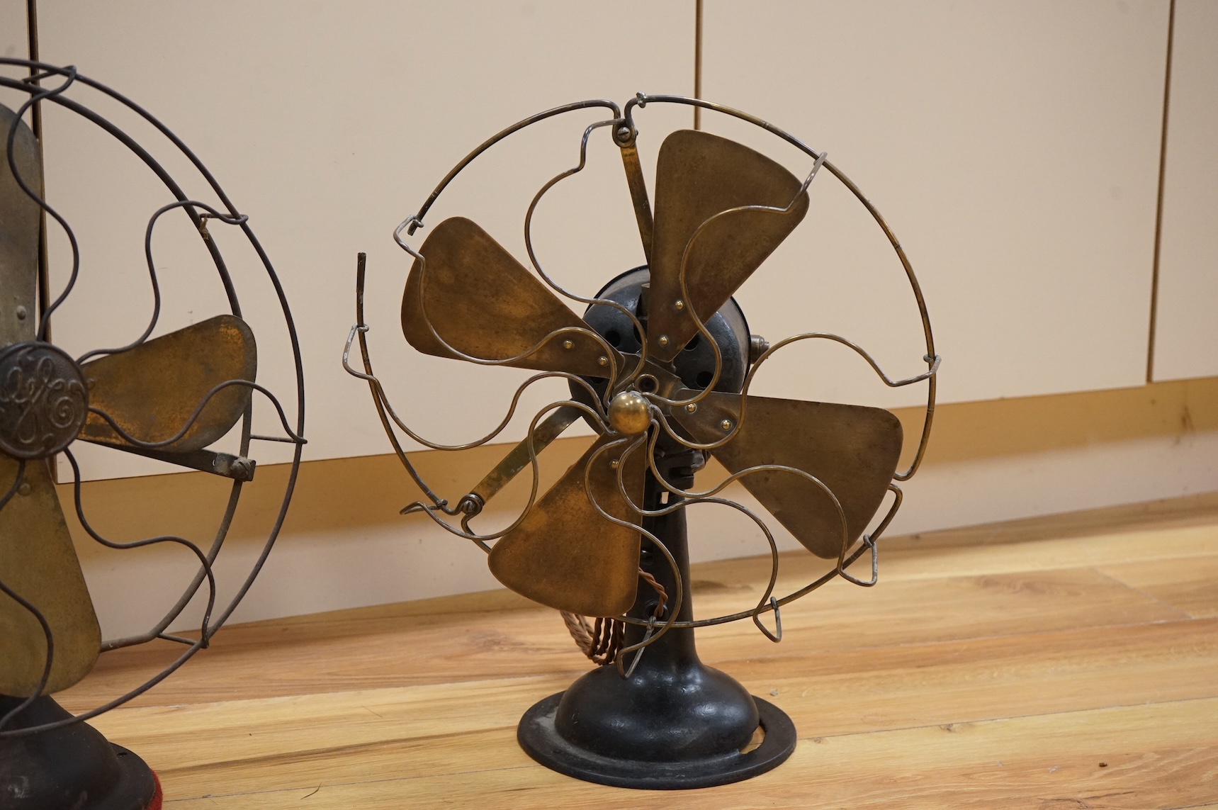 Two early 20th century electric fans, one by General Electric, 43cm high